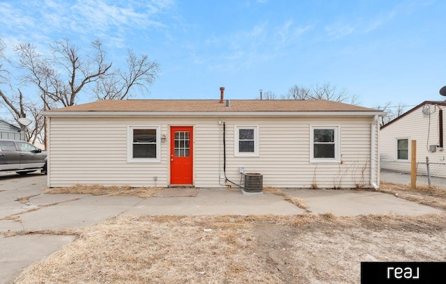 rear view of property featuring a patio and cooling unit