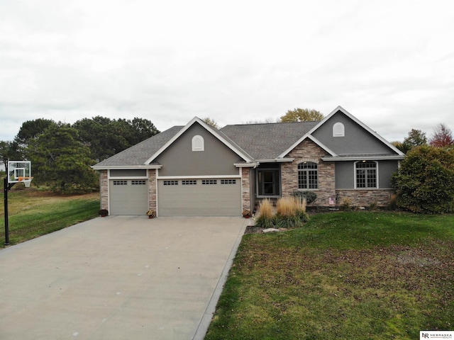 view of front of property featuring a garage and a front lawn