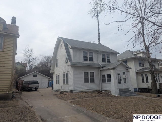 view of property with a garage and an outdoor structure