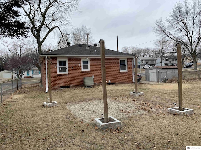 rear view of house featuring central air condition unit