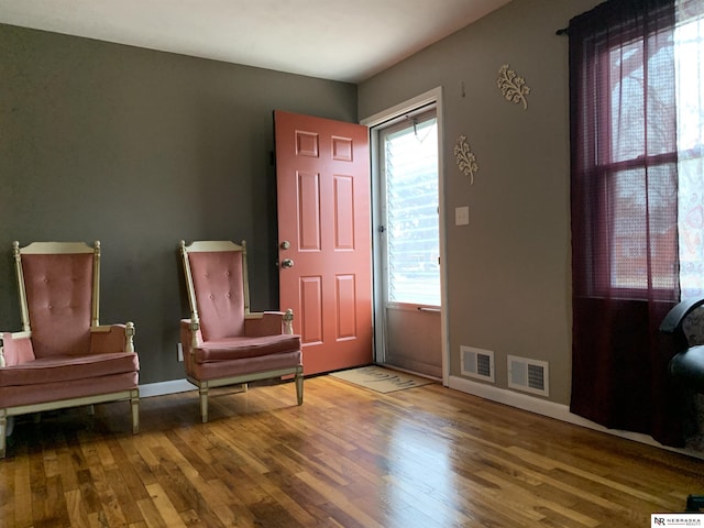 living area with hardwood / wood-style floors