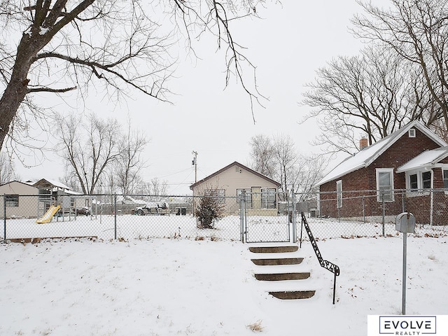 snowy yard featuring a playground