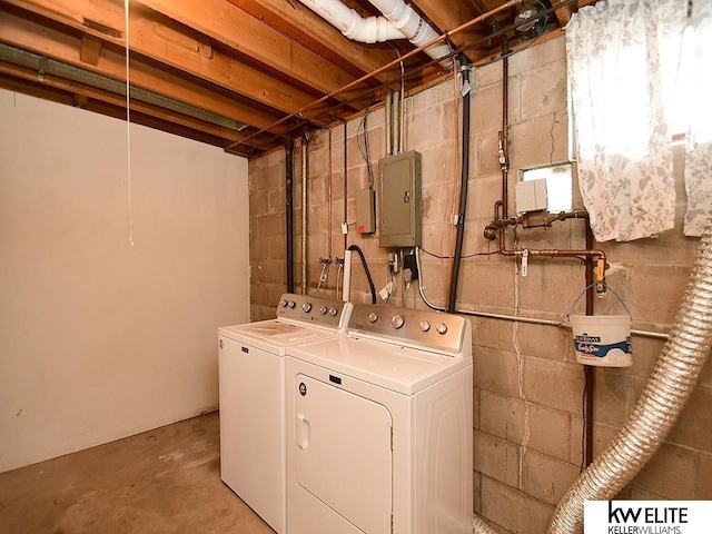 clothes washing area with electric panel and washer and clothes dryer