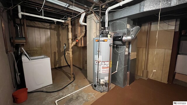 utilities with water heater, washer / clothes dryer, and heating unit