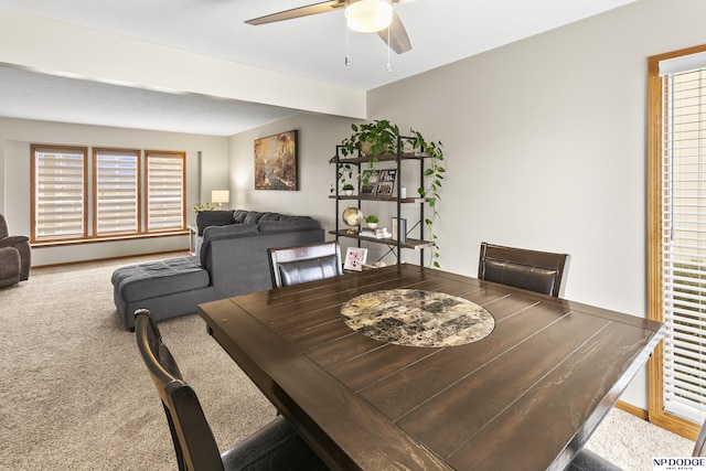 carpeted dining area featuring ceiling fan