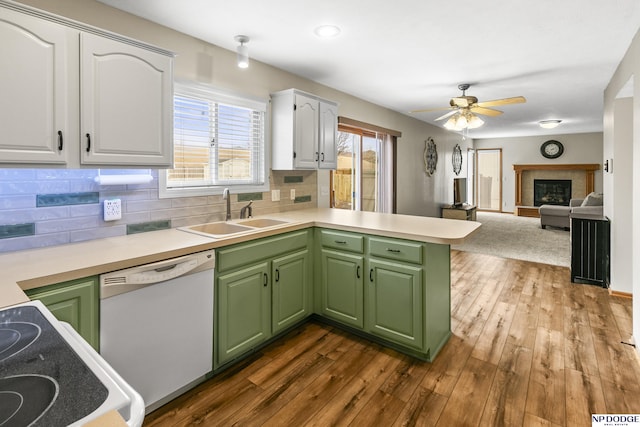 kitchen featuring white cabinetry, sink, green cabinetry, and dishwasher