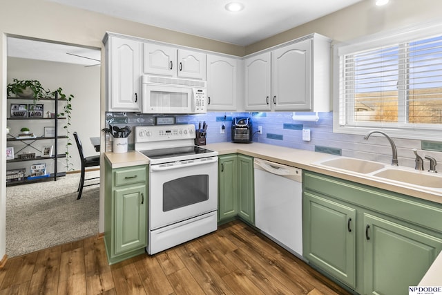 kitchen with dark hardwood / wood-style floors, white cabinetry, sink, backsplash, and white appliances