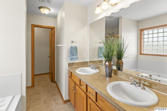 bathroom featuring a relaxing tiled tub and vanity