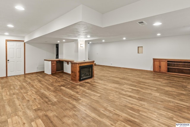 basement with hardwood / wood-style floors