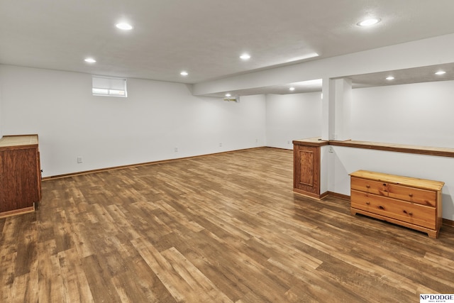 basement with dark hardwood / wood-style flooring