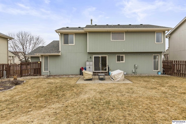 back of property with a patio and a lawn