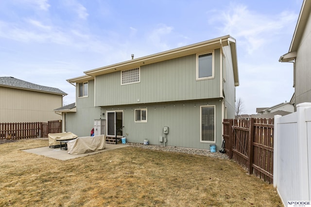 back of property with a patio and a lawn