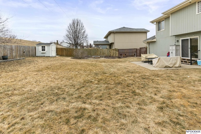 view of yard with a storage shed and a patio