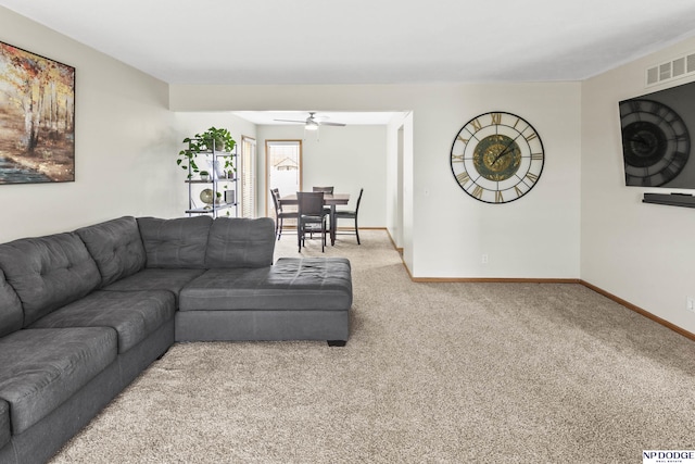 carpeted living room featuring ceiling fan