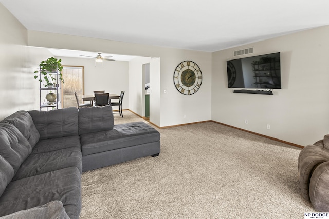 living room with ceiling fan and carpet floors