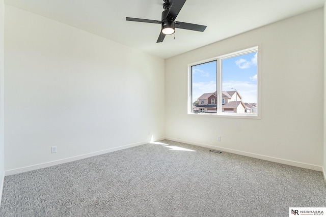 unfurnished room featuring ceiling fan and carpet