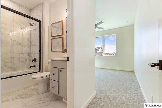 full bathroom featuring toilet, ceiling fan, vanity, and bath / shower combo with glass door