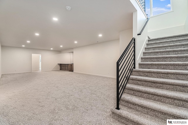 staircase featuring carpet floors