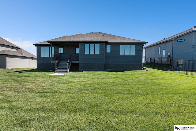 rear view of house with a yard