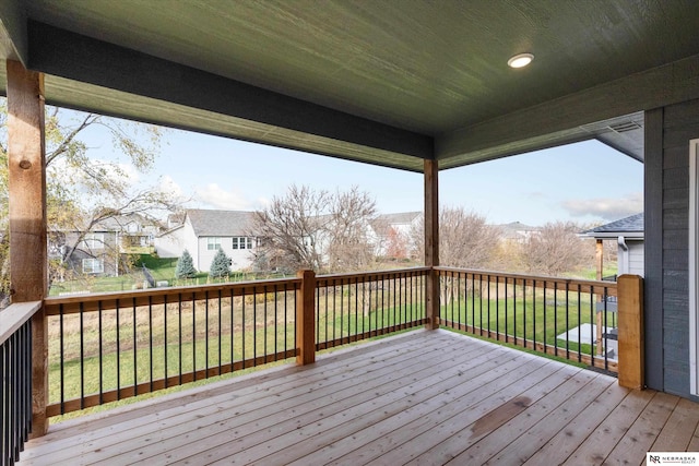 deck with a lawn and a residential view