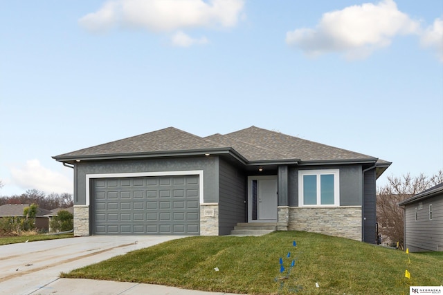 prairie-style home featuring driveway, stone siding, a garage, and a front yard