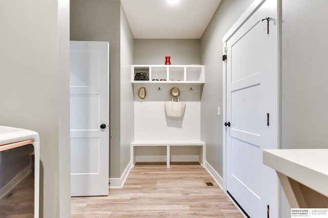 mudroom featuring washer / dryer and light hardwood / wood-style flooring