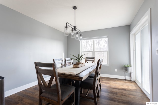 dining room featuring a notable chandelier and dark hardwood / wood-style flooring