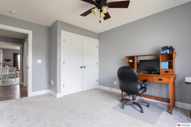 carpeted office with ceiling fan