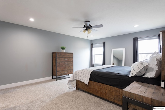 bedroom featuring light colored carpet and ceiling fan