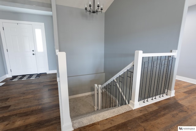 entrance foyer featuring dark hardwood / wood-style floors and a chandelier