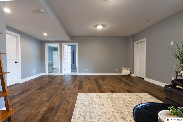 unfurnished living room with dark wood-type flooring