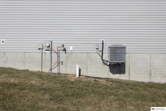 exterior space with central AC and a lawn