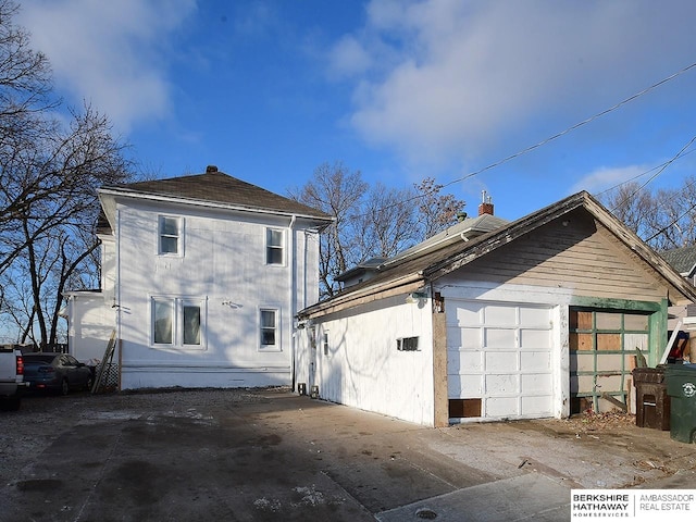 rear view of property featuring a garage