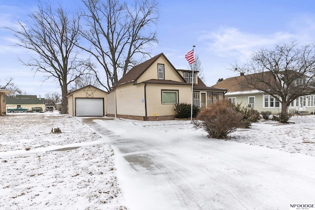 view of front facade featuring a garage and an outbuilding