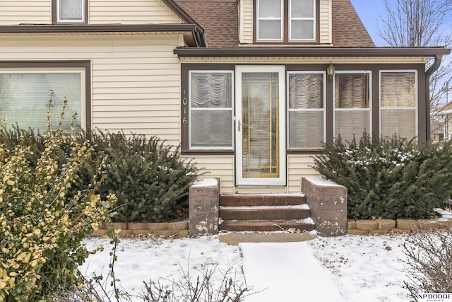 view of snow covered property entrance