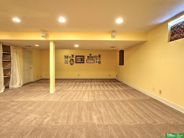 finished below grade area featuring carpet, baseboards, and recessed lighting