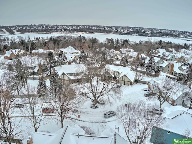 snowy aerial view with a residential view