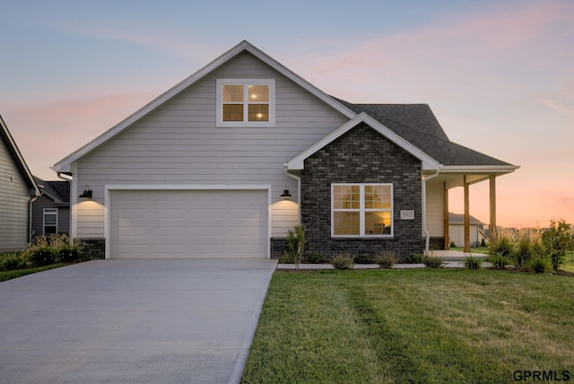 view of front of home with a yard and a garage