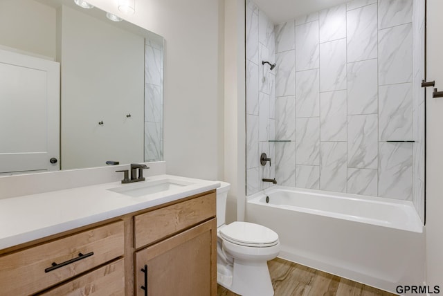 full bathroom featuring vanity, toilet, tiled shower / bath combo, and wood-type flooring