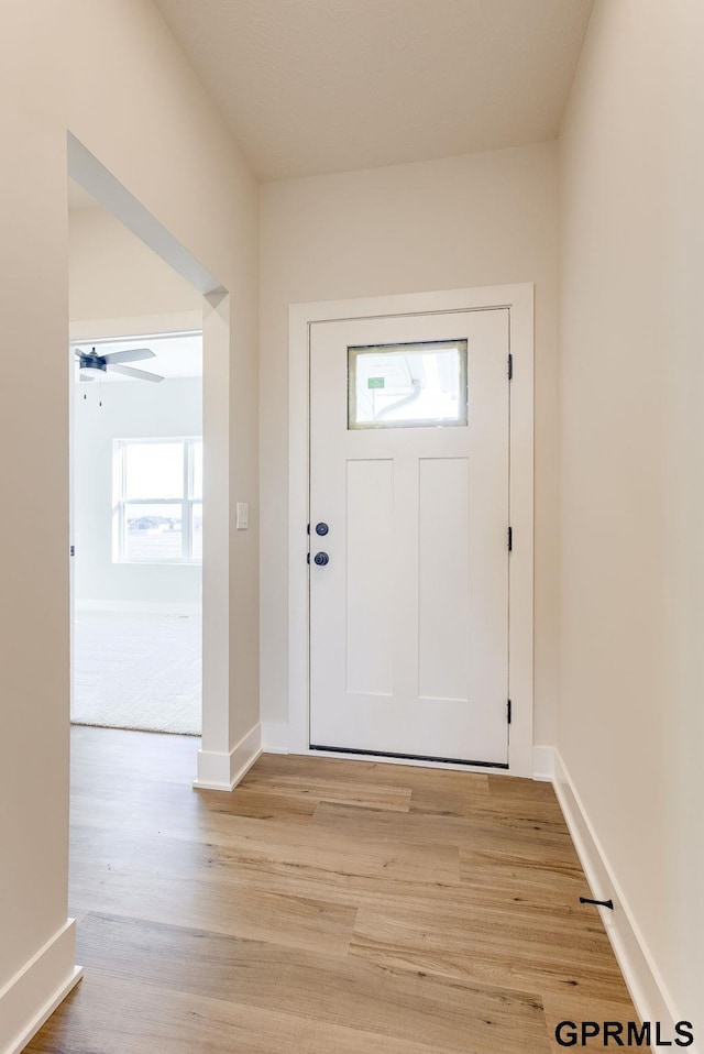 foyer featuring ceiling fan and light hardwood / wood-style floors