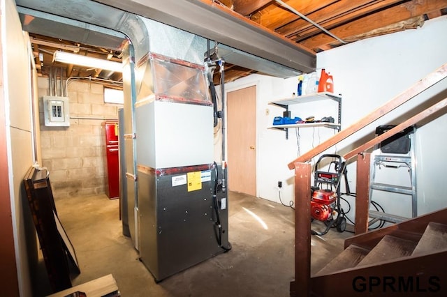 utility room with heating unit and electric panel