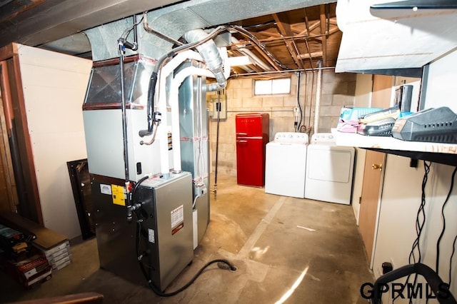 basement with heating unit and washer and clothes dryer