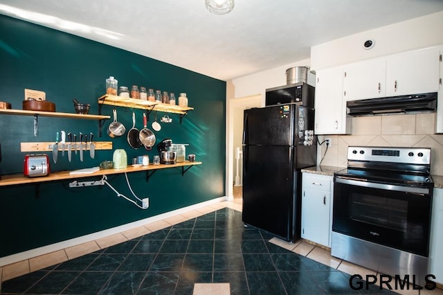 kitchen featuring electric stove, white cabinetry, tile patterned floors, and black fridge