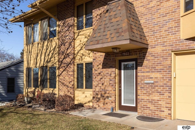 view of exterior entry with a lawn