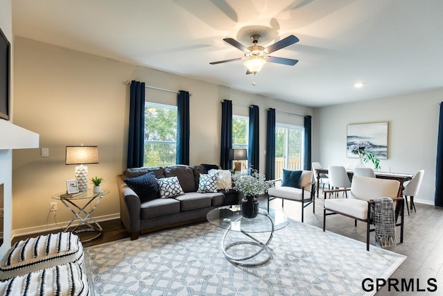 living room featuring light hardwood / wood-style floors and ceiling fan