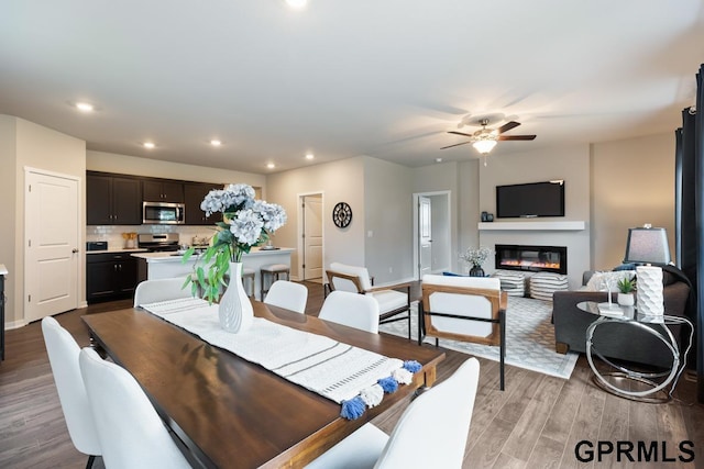 dining space with ceiling fan and light hardwood / wood-style floors