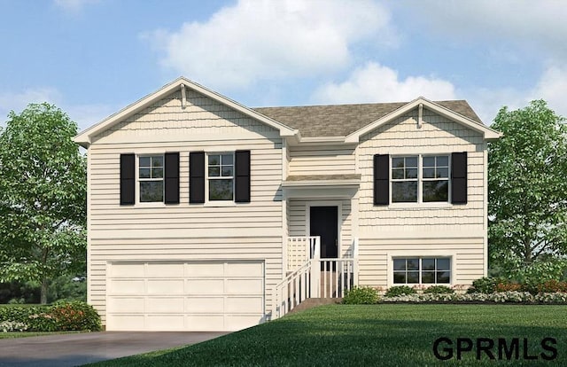 bi-level home featuring a garage and a front lawn