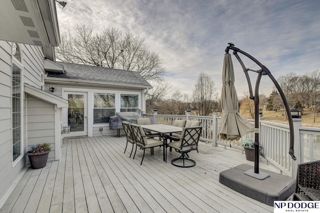 wooden deck with a grill