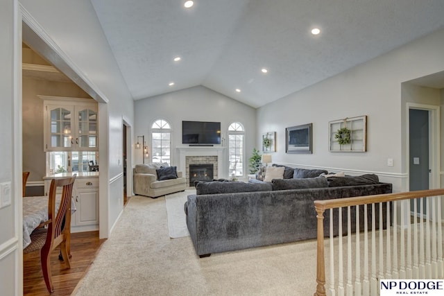 living room featuring vaulted ceiling and light wood-type flooring