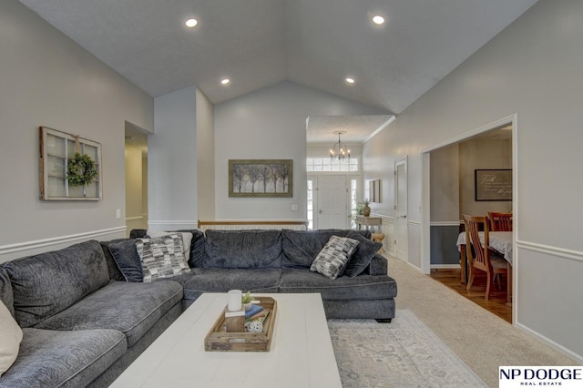 living room featuring high vaulted ceiling and a chandelier